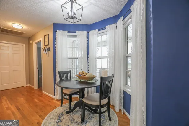 a view of a dining room with furniture and window