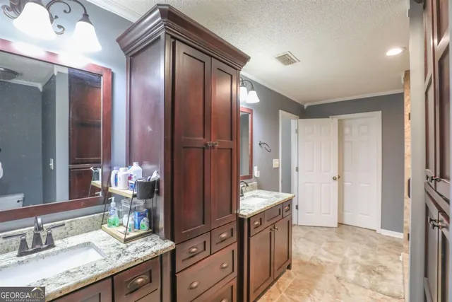 a spacious bathroom with a granite countertop sink and a mirror