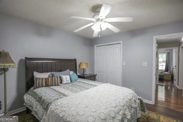 a bedroom with a large bed and a chandelier