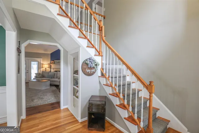 a view of entryway and hall with wooden floor