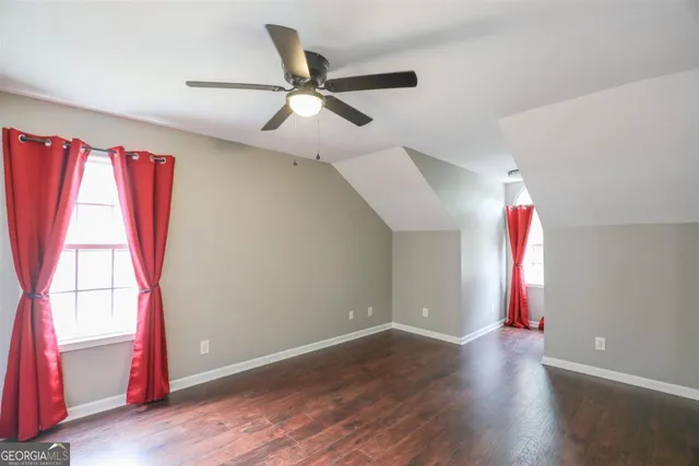 a view of a room with wooden floor and windows