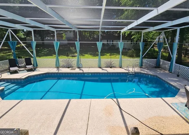 a view of a swimming pool with a lounge chairs