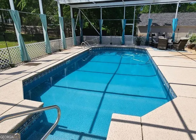 a view of a patio with table and chairs and wooden floor