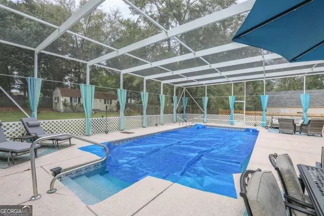 a view of a livingroom with furniture and floor to ceiling window