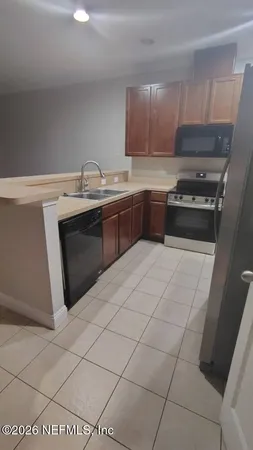 a kitchen with stainless steel appliances a sink stove and cabinets