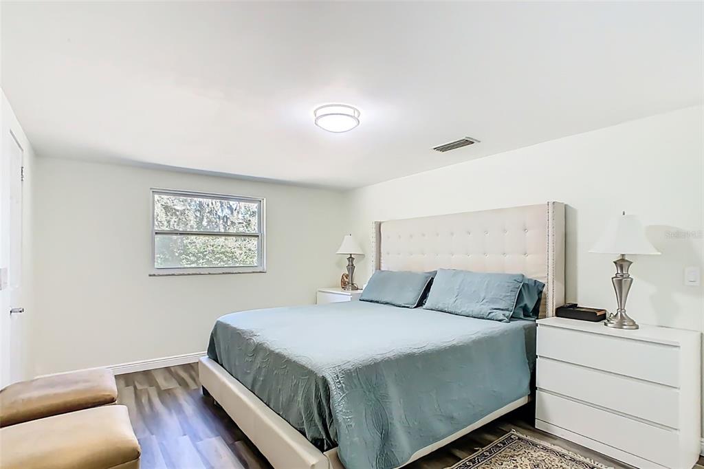 1700 South Miller Road Valrico, FL 33594 - Photo 20 of 53 a bedroom with a bed and a night stand