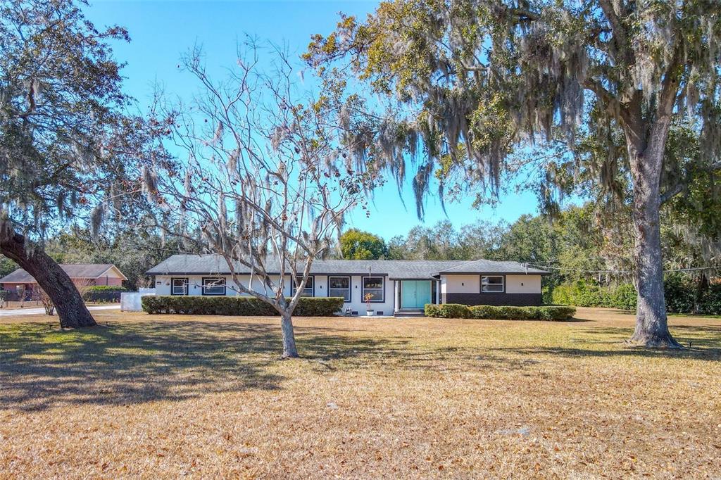 1700 South Miller Road Valrico, FL 33594 - Photo 2 of 53 view of house with trees in front of it