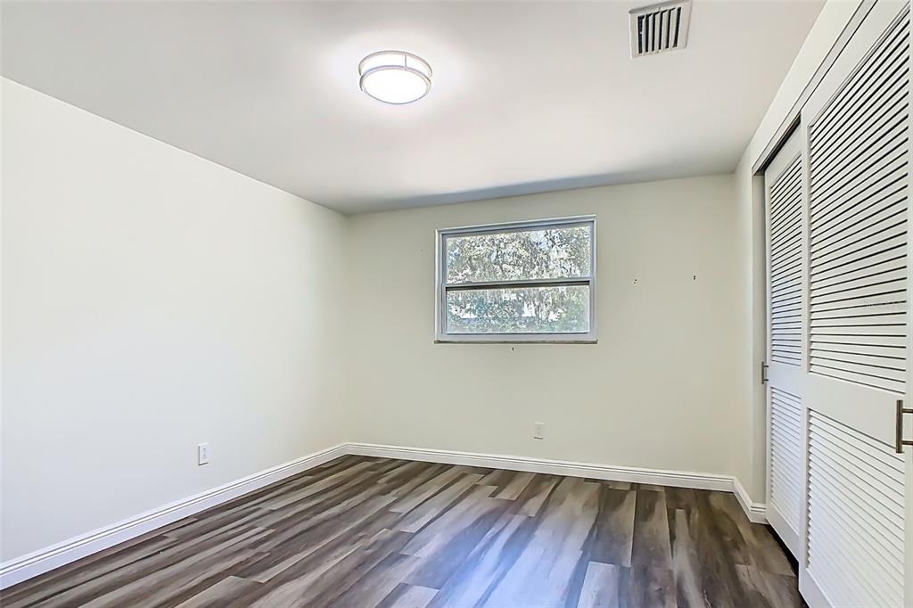 1700 South Miller Road Valrico, FL 33594 - Photo 26 of 53 an empty room with wooden floor and windows