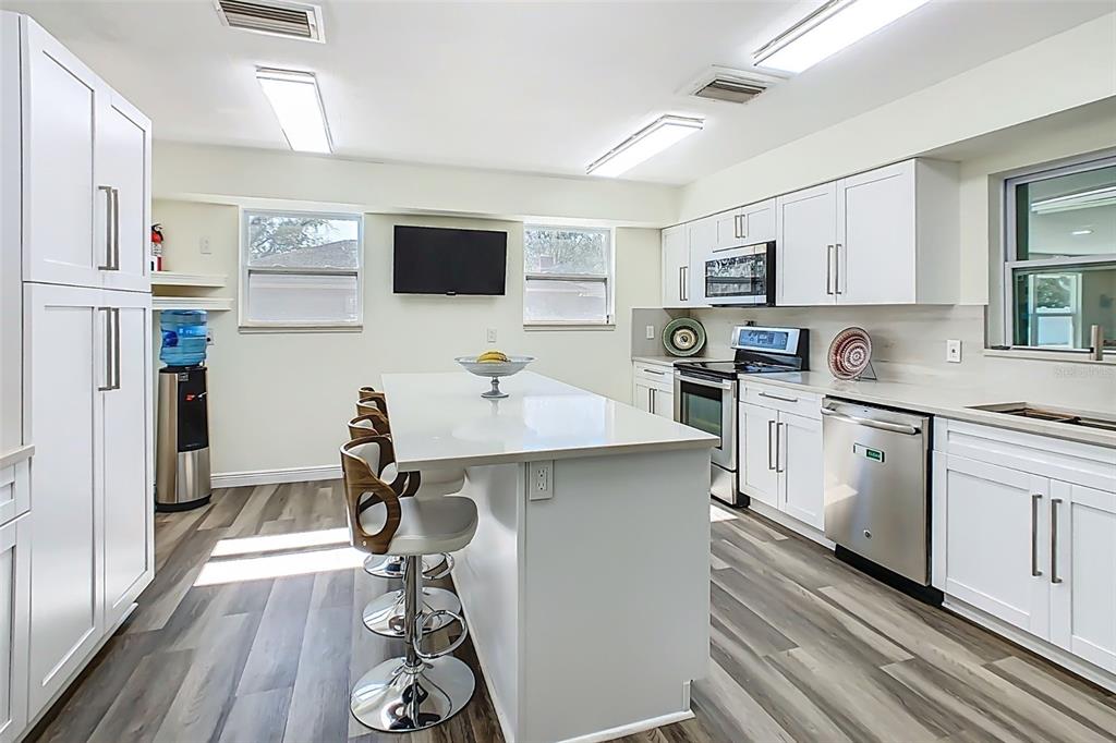 1700 South Miller Road Valrico, FL 33594 - Photo 4 of 53 a kitchen with stainless steel appliances a sink stove refrigerator and cabinets