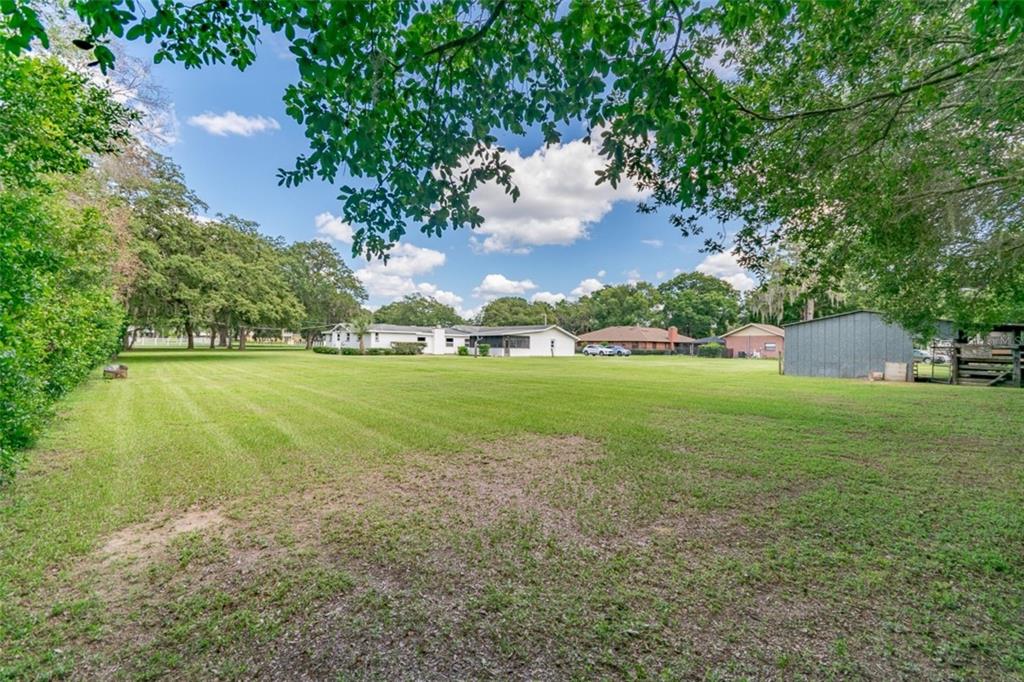 1700 South Miller Road Valrico, FL 33594 - Photo 44 of 53 a view of yard with swimming pool and green space