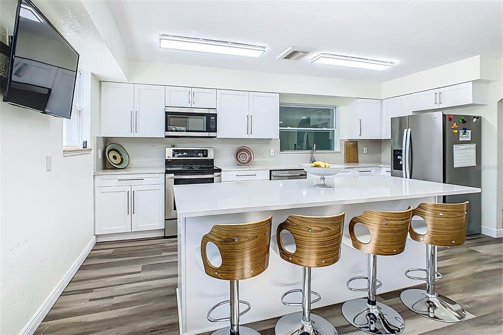 1700 South Miller Road Valrico, FL 33594 - Photo 5 of 53 a kitchen with stainless steel appliances a stove refrigerator sink and microwave