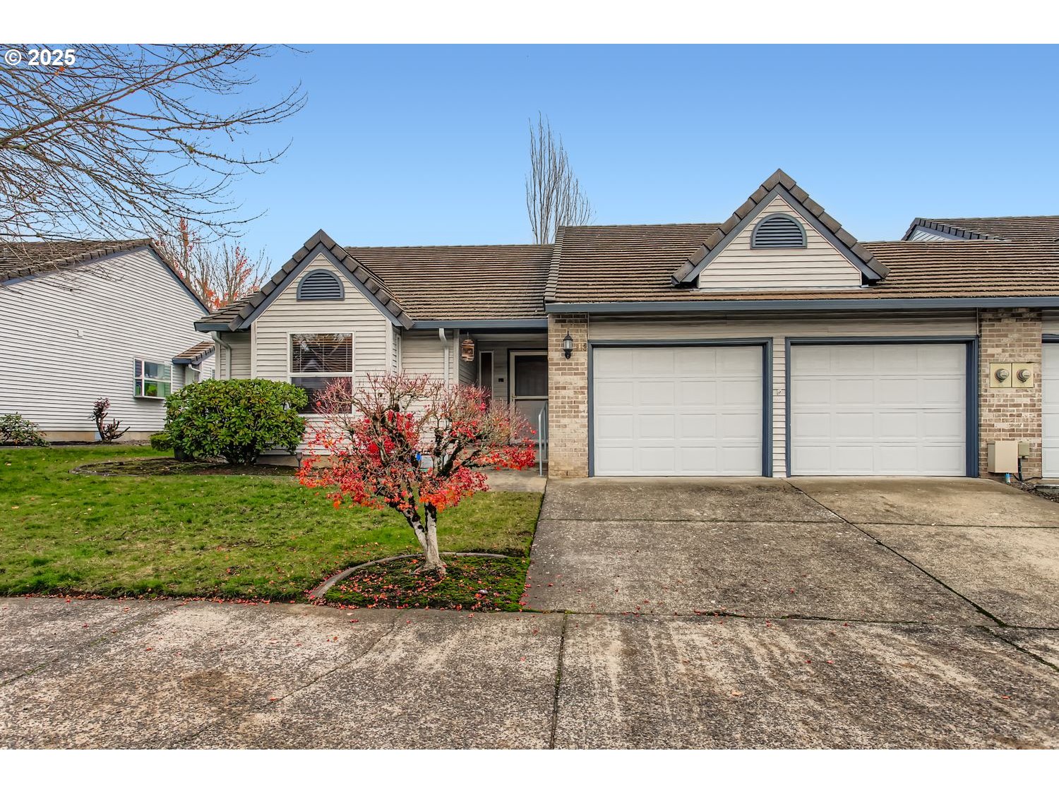 15917 Northeast Union Road, Unit 113 Ridgefield, WA 98642 - Photo 1 of 27 a front view of a house with a yard and garage