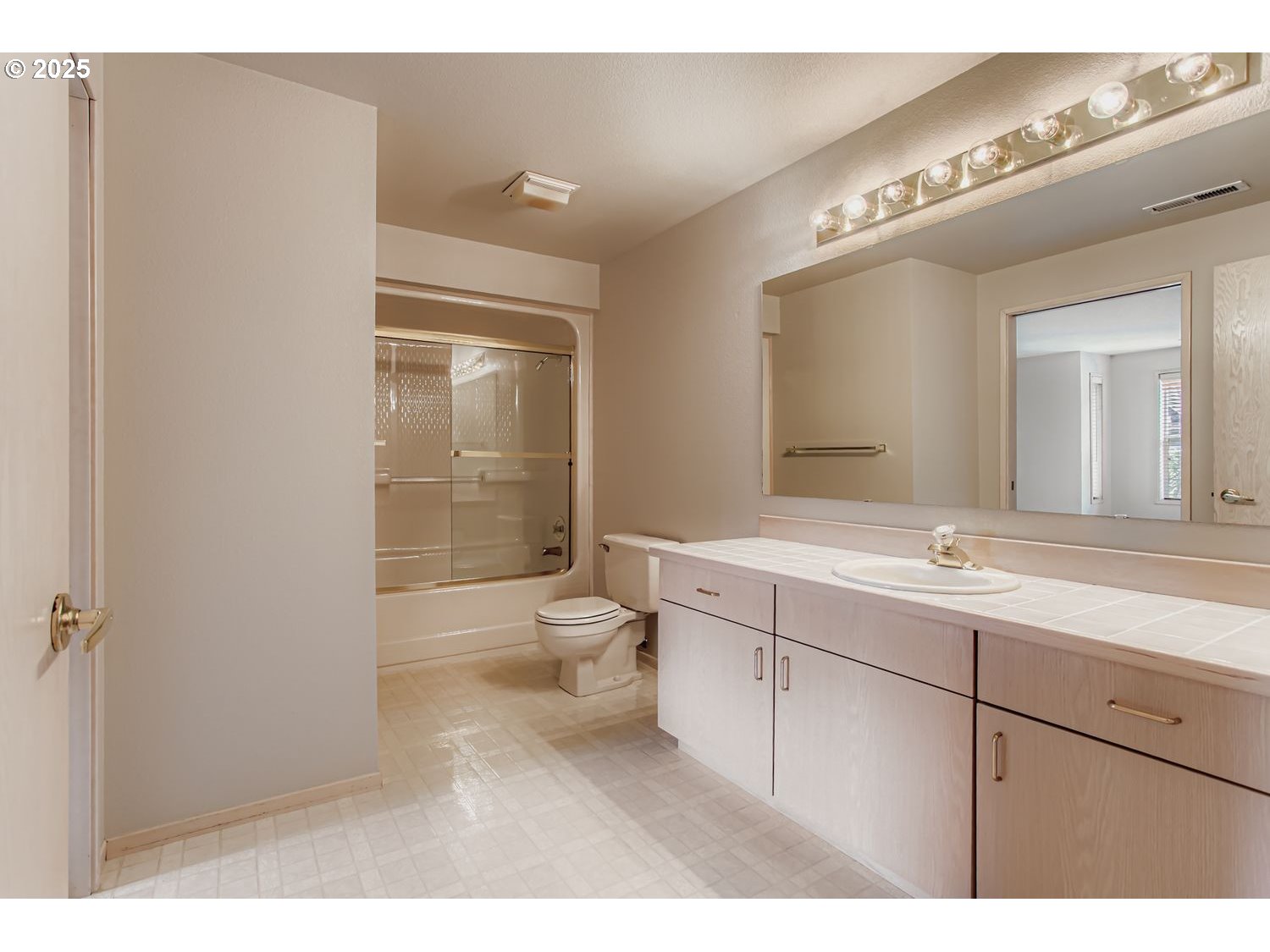 15917 Northeast Union Road, Unit 113 Ridgefield, WA 98642 - Photo 20 of 27 a bathroom with a granite countertop sink a toilet a mirror and shower