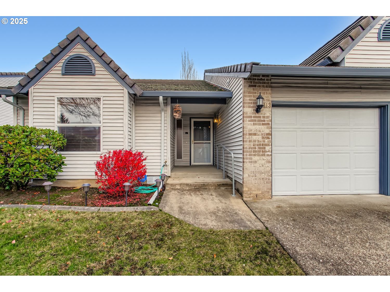 15917 Northeast Union Road, Unit 113 Ridgefield, WA 98642 - Photo 2 of 27 a front view of a house with a yard