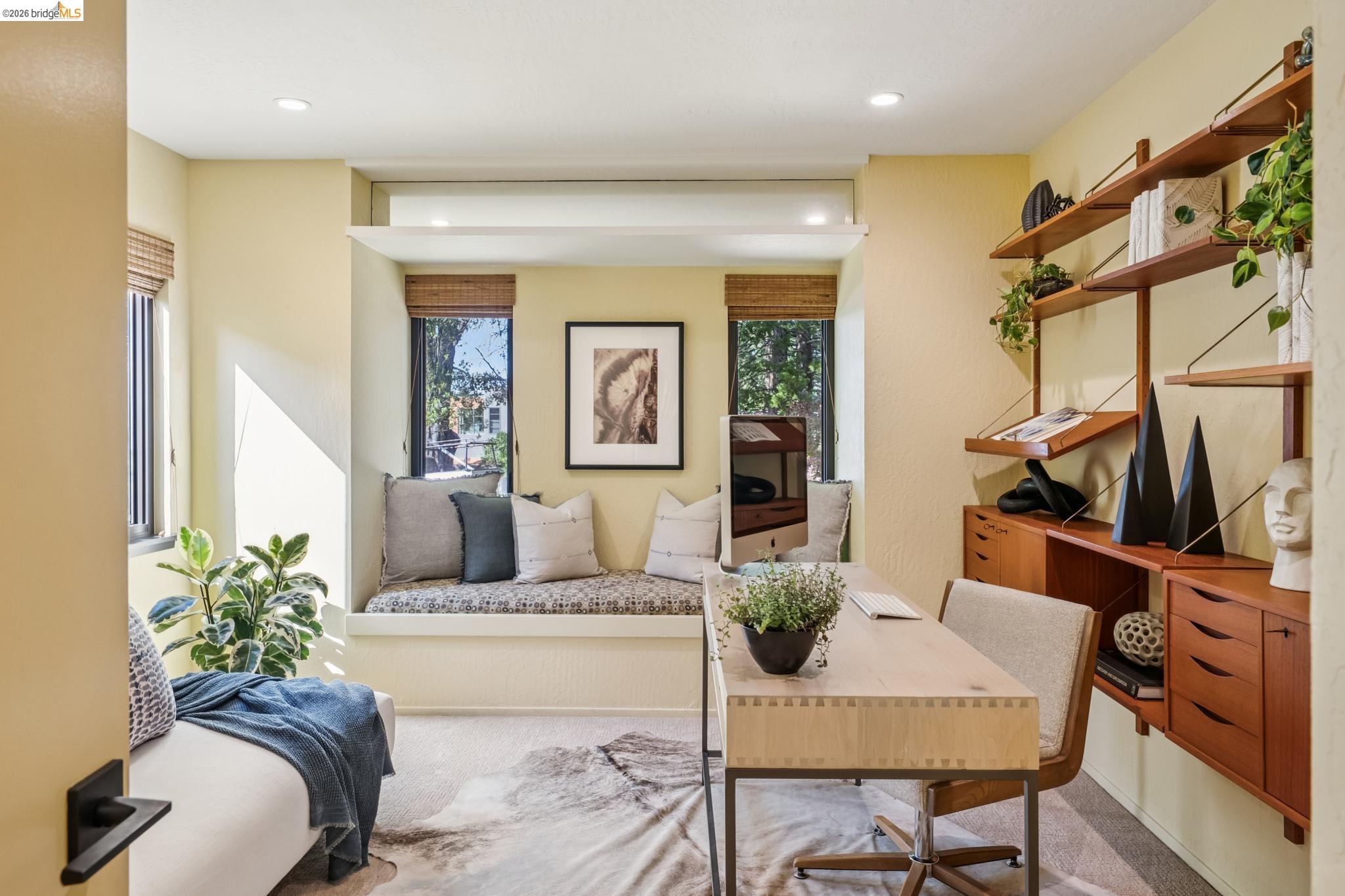 576 Vistamont Avenue Berkeley, CA 94708 - Photo 26 of 33 Built-in window seat, recessed lighting, wall-mounted shelving unit, wood-finish desktop, and two windows with woven blinds