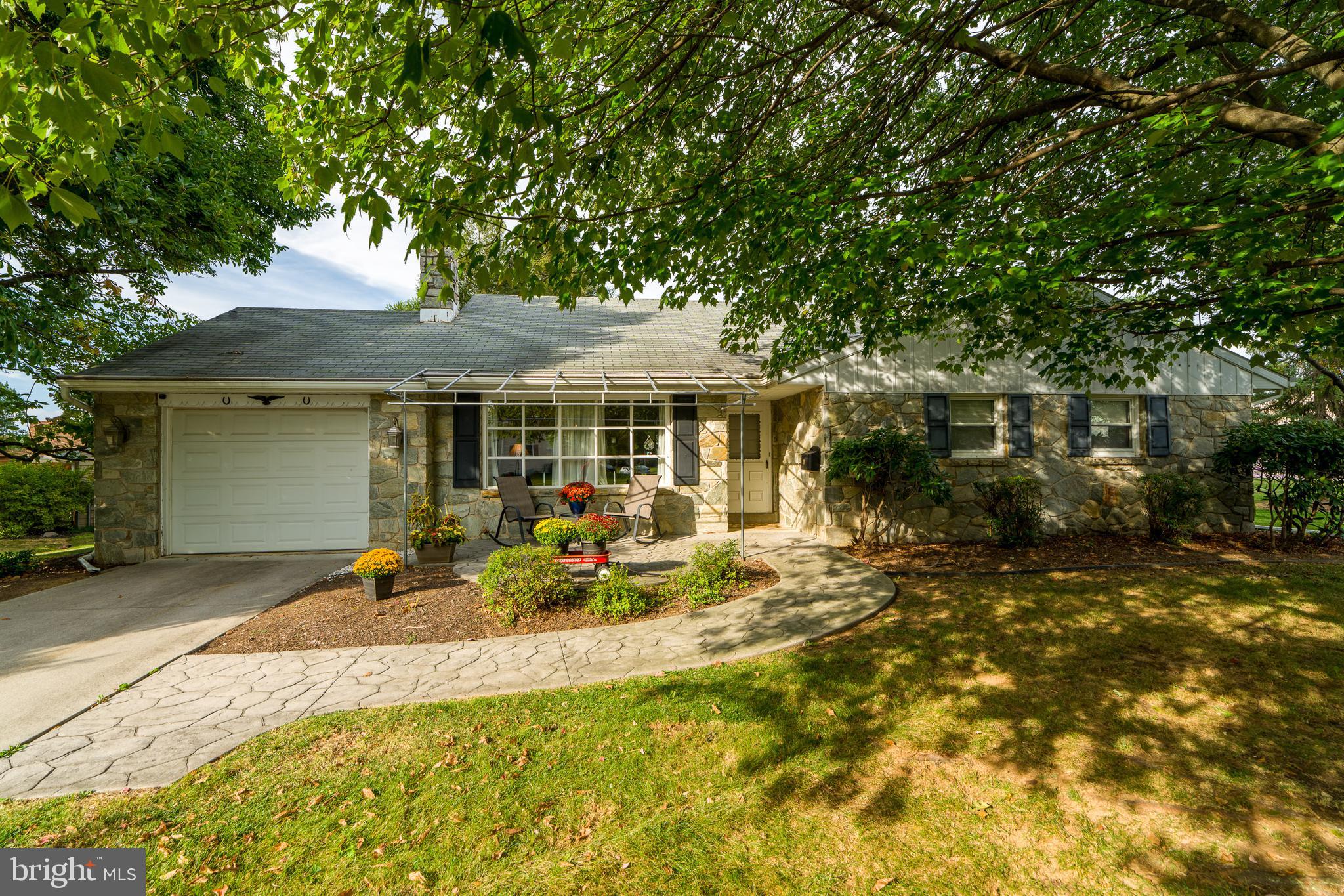 a front view of a house with a garden and porch