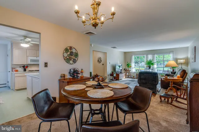 a view of a dining room with furniture and chandelier
