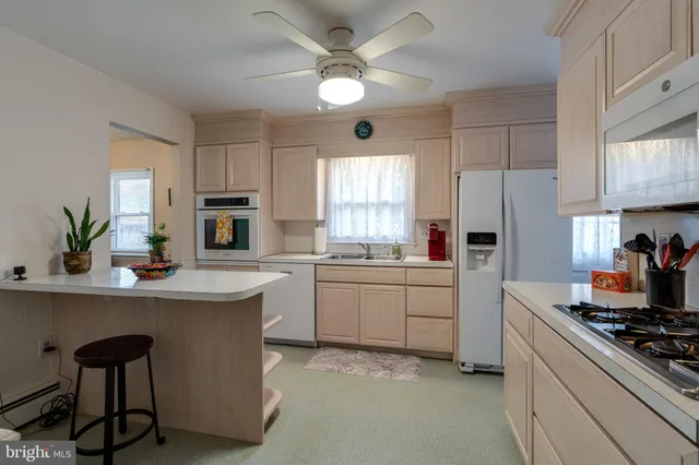 a kitchen with a stove a sink and a refrigerator