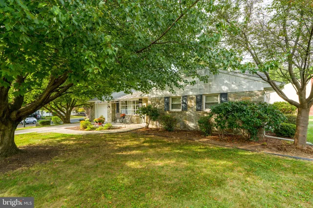 a view of a house with a yard and sitting area