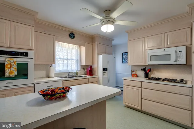 a kitchen with stainless steel appliances a sink stove and cabinets