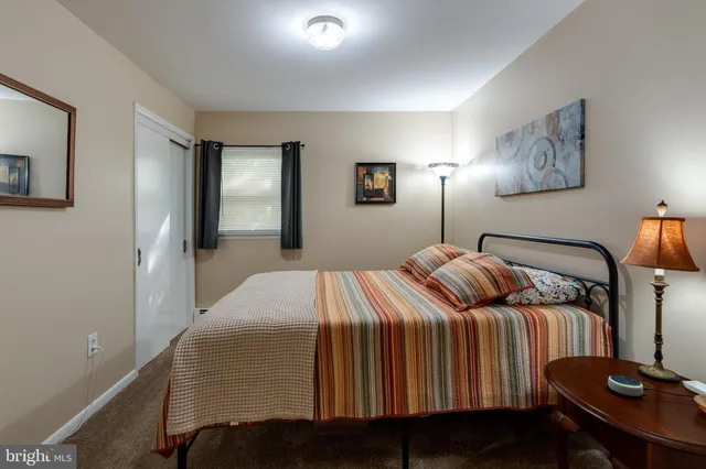 a bedroom with a bed and lamp