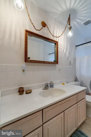 a bathroom with a sink a vanity and a mirror