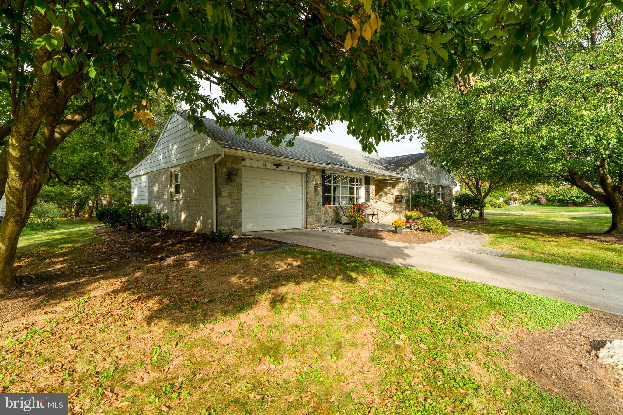 201 Cardinal Road Lititz, PA 17543 - Photo 5 of 50 a view of a white house with a large pool and a yard with plants and large trees