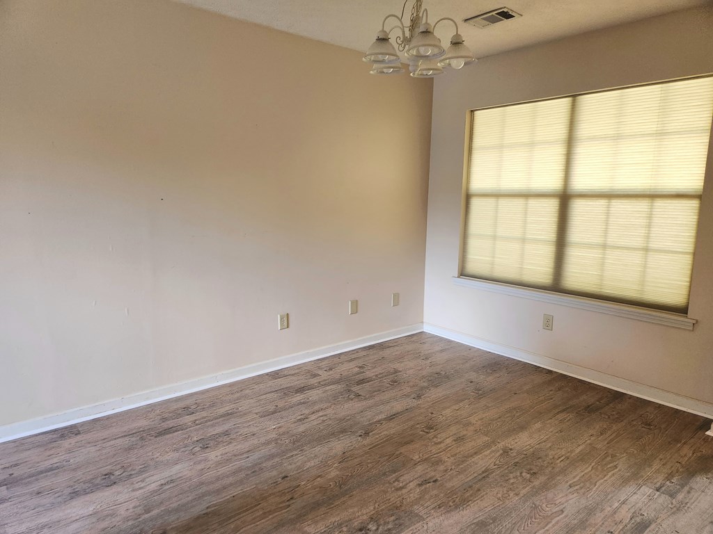 7312 Cedar Creek Loop Columbus, GA 31904 - Photo 4 of 17 wooden floor in an empty room with a window