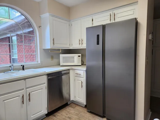 a kitchen with a refrigerator and sink
