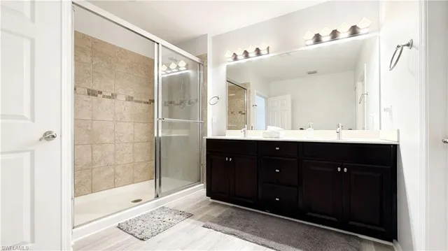 a bathroom with a shower sink and mirror