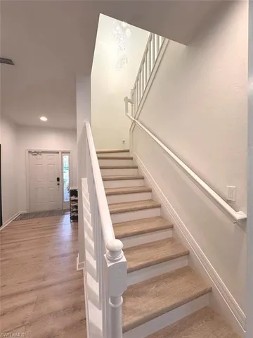 a view of entryway and hall with wooden floor
