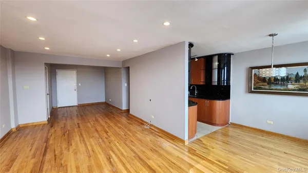 a view of hallway with a large window and wooden floor