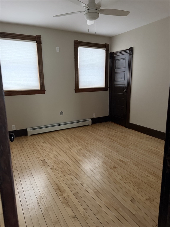 53 Barclay Street, Unit 1 Worcester, MA 01604 - Photo 16 of 17 an empty room with wooden floor and windows