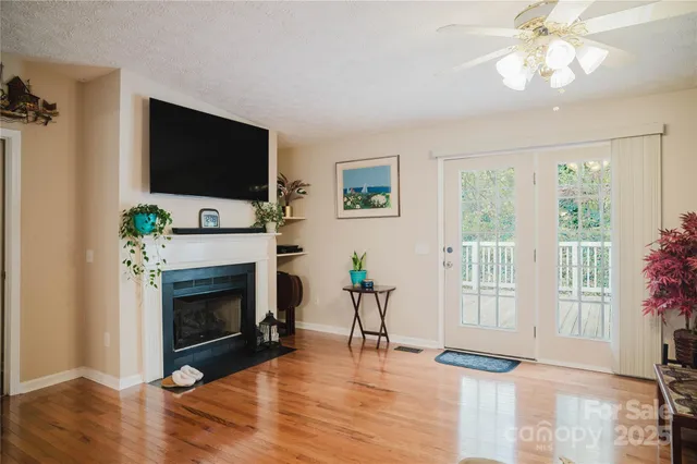 a bedroom with a bed and large windows