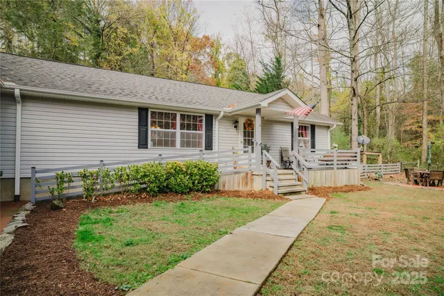 a front view of a house with yard and green space