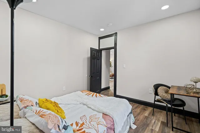 a view of a big room with wooden floor and windows