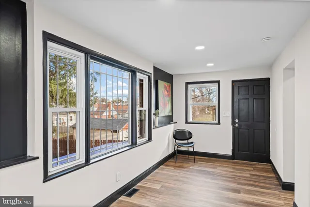 a big room with wooden floor and windows