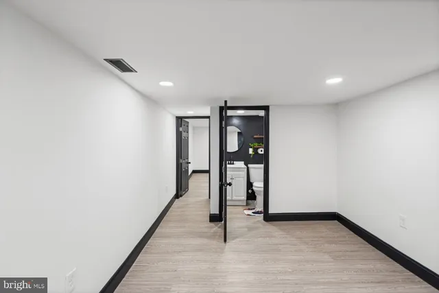a bathroom with a sink toilet and a mirror