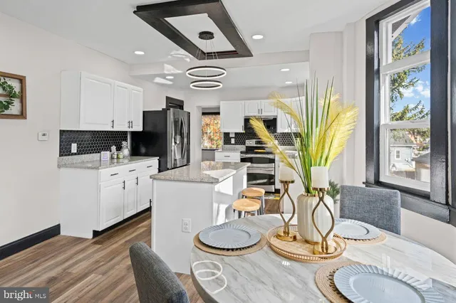 a room with stainless steel appliances furniture and a large window