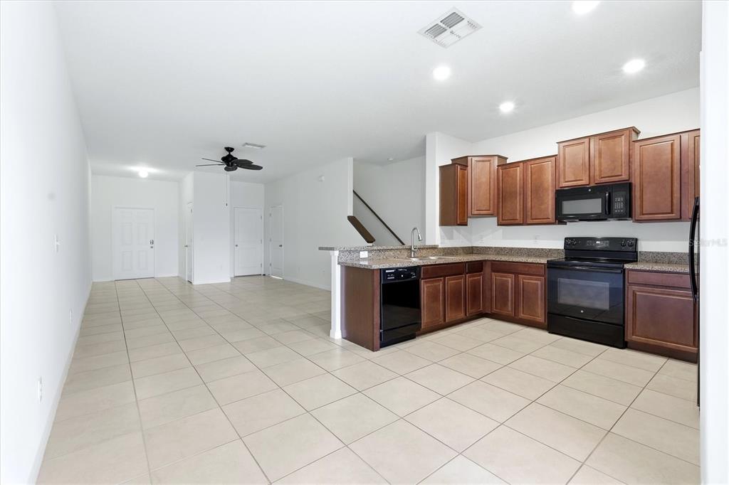 12909 Dream Catcher Way Riverview, FL 33579 - Photo 11 of 32 a kitchen with stainless steel appliances a sink and a refrigerator
