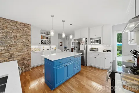 a kitchen with cabinets a sink and appliances