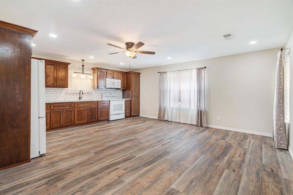 201 Farm To Market 906 Powderly, TX 75473 - Photo 27 of 37 a view of a kitchen with a sink and a refrigerator