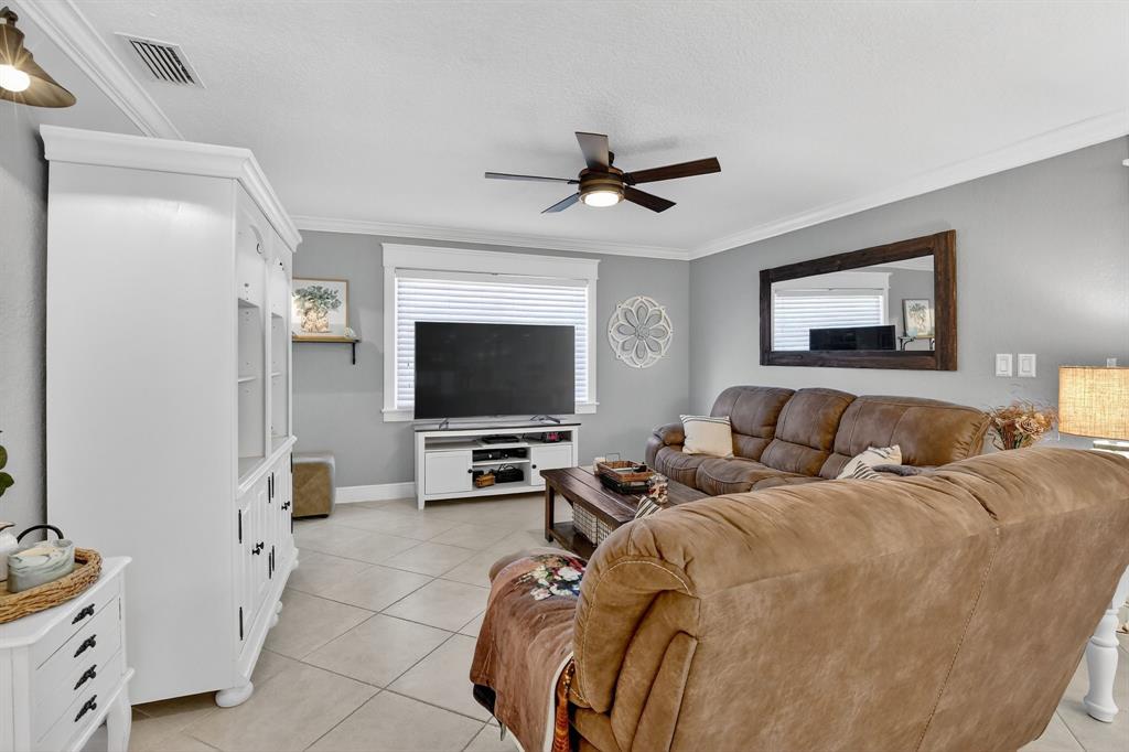 11611 Southwest 52nd Street Cooper City, FL 33330 - Photo 18 of 45 a living room with furniture and a flat screen tv