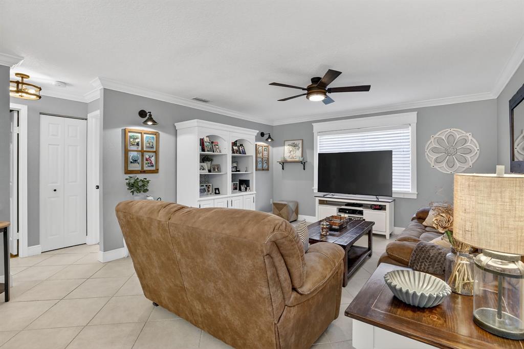 11611 Southwest 52nd Street Cooper City, FL 33330 - Photo 19 of 45 a living room with furniture and a flat screen tv