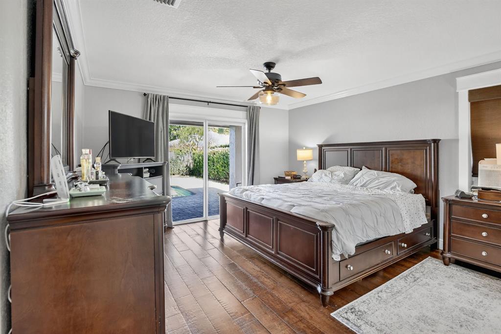 11611 Southwest 52nd Street Cooper City, FL 33330 - Photo 23 of 45 a spacious bedroom with a bed a flat screen tv and a large window