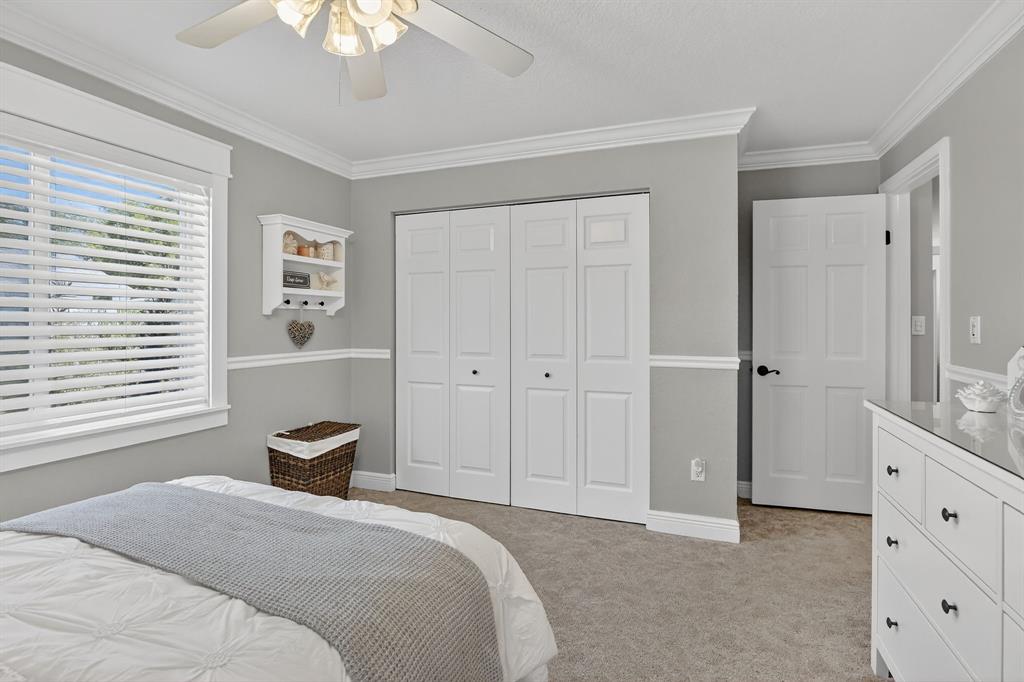 11611 Southwest 52nd Street Cooper City, FL 33330 - Photo 32 of 45 a bedroom with a bed and a chandelier