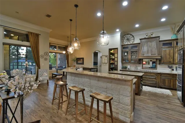 a hallway with beautiful frames and flower vase