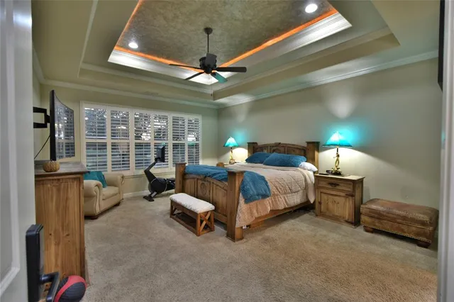 a spacious bathroom with a granite countertop sink a large mirror and a shower