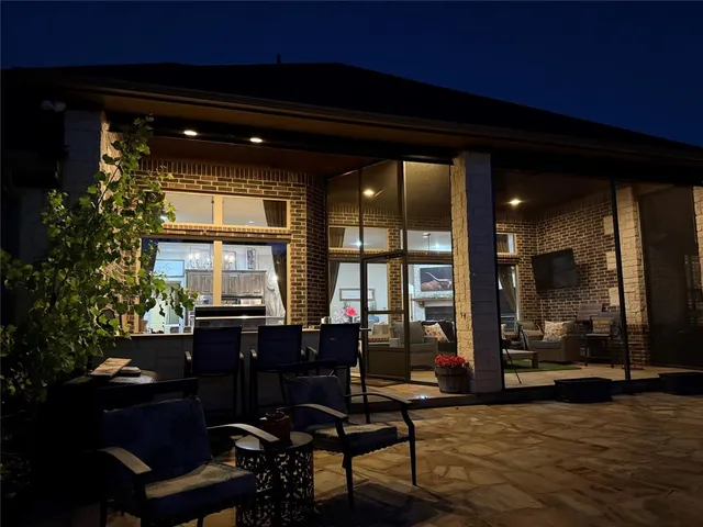a indoor swimming pool with barbeque oven table and chairs