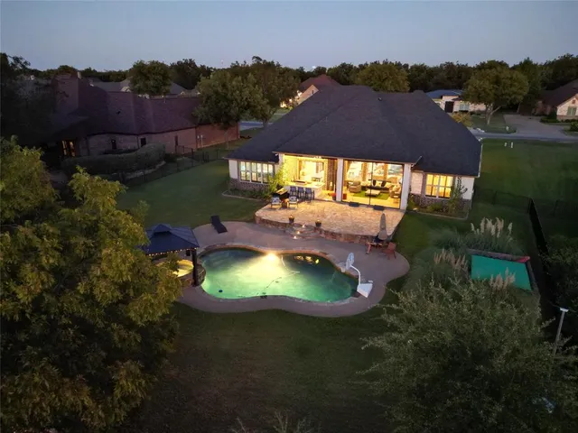 an aerial view of a house with a yard
